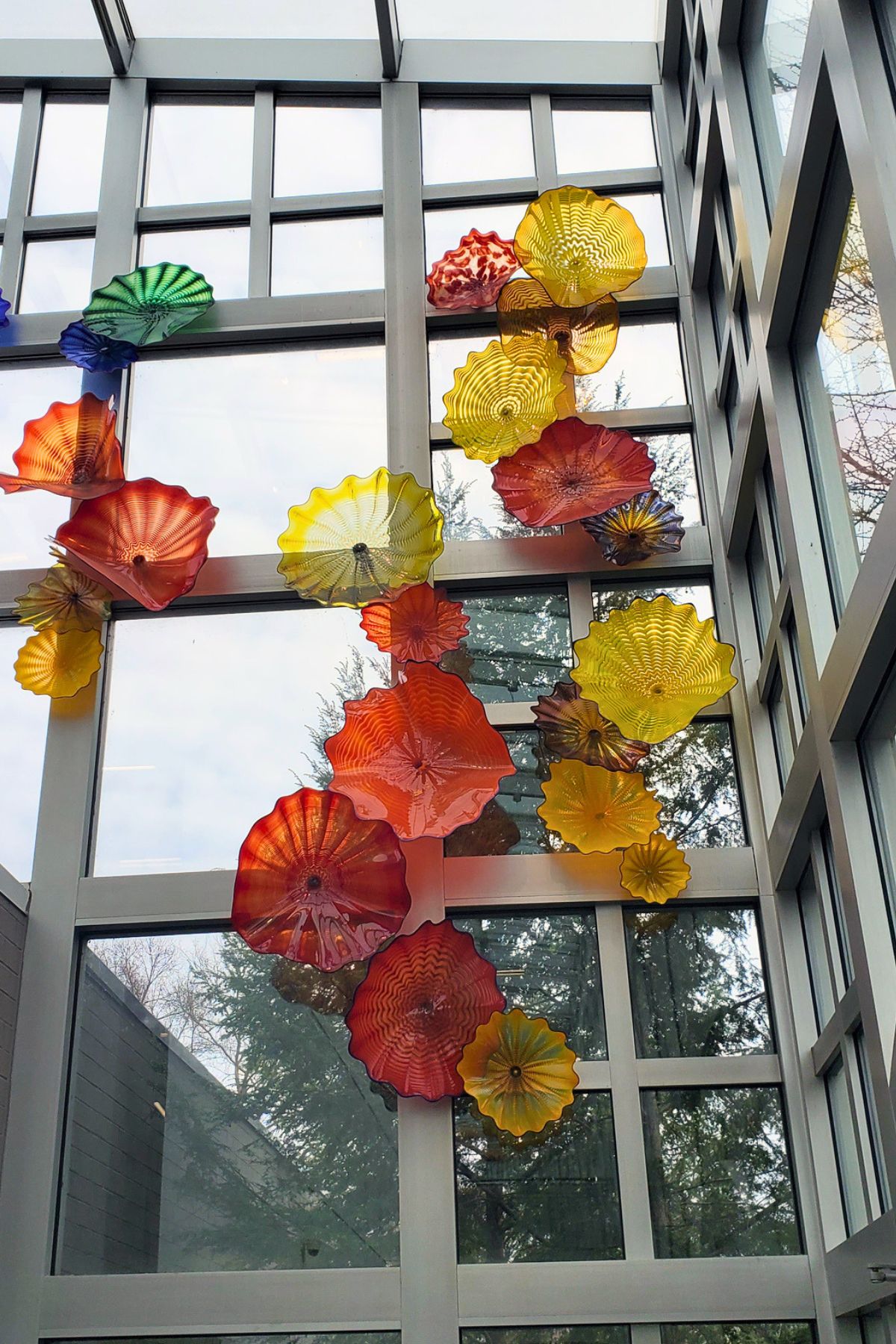 rippled red and yellow glass sculpture going up the wall at Franklin Park Conservatory