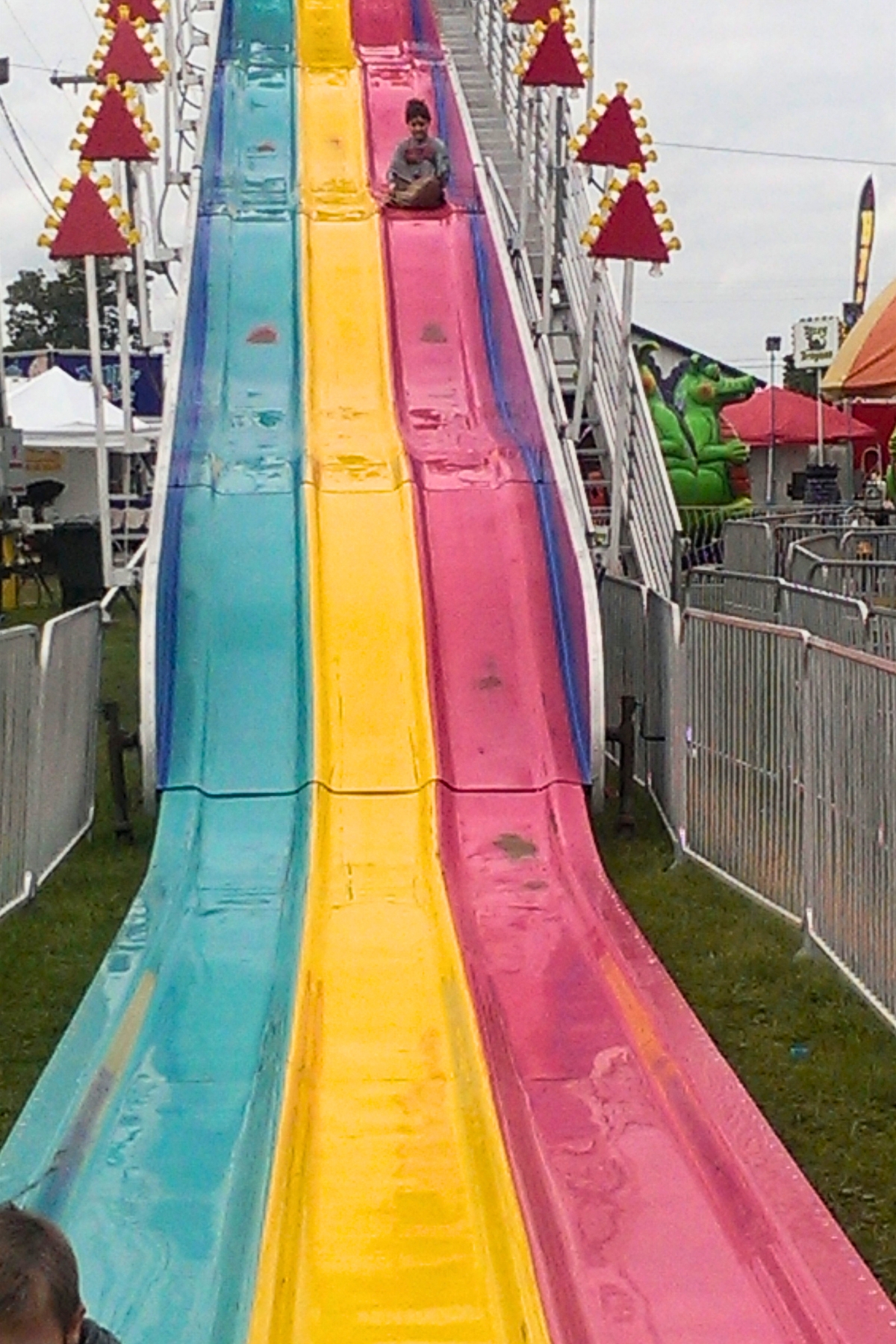 green yellow and pink slides at the fair